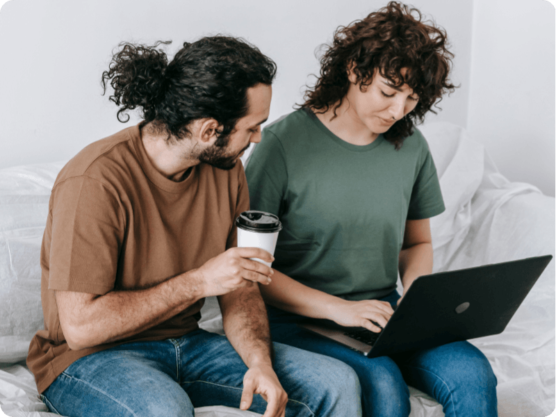 young couple using their laptop for help