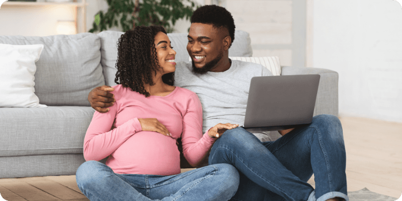 young couple sat with their laptop