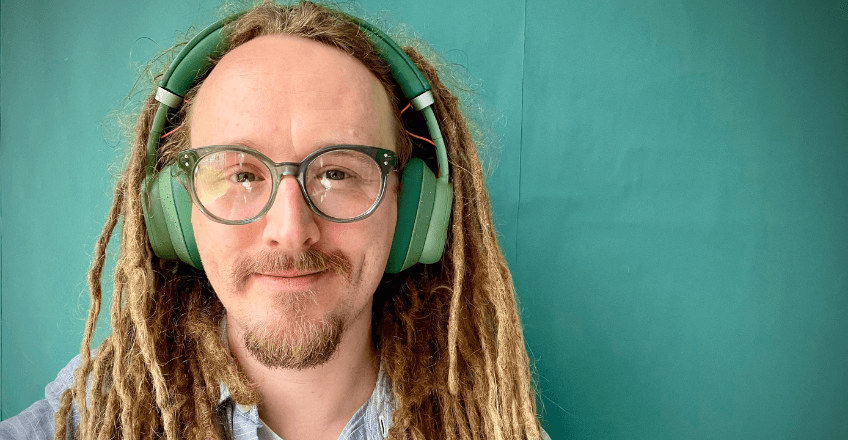 man wearing Fairbuds XL headphones