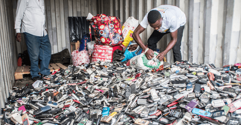 two workers sorting through e-waste