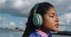 woman wearing her green Fairbuds XL headphones