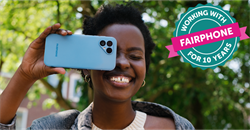 woman holding Fairphone 5 to her face