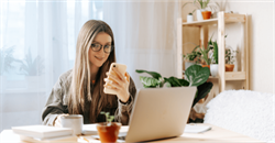 young woman using her laptop and mobile