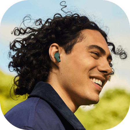 Man wearing black Fairbuds XL headphones