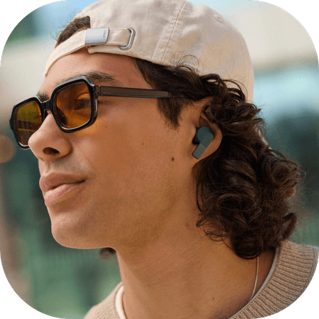woman wearing black Fairbuds XL headphones
