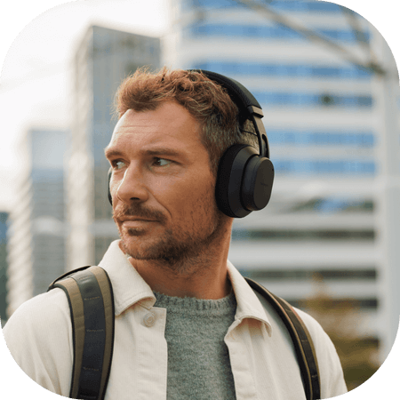 Man wearing black Fairbuds XL headphones