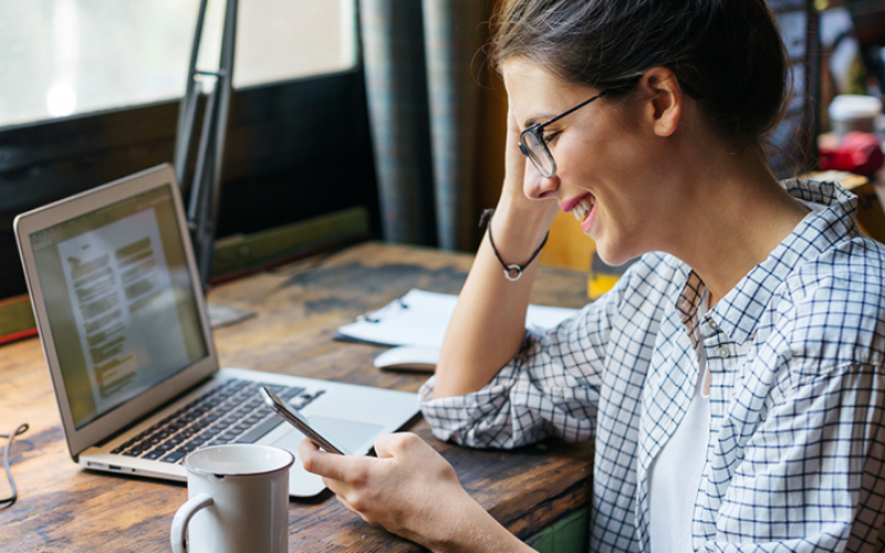 Lady on laptop and using mobile