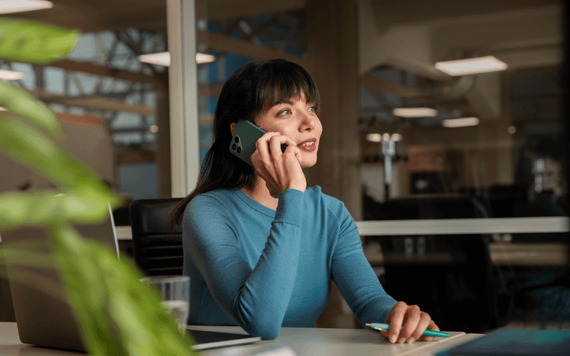 Woman making a call from office on Fairphone 4
