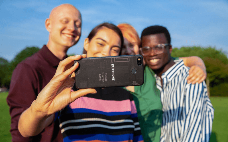 People taking a group selfie with Fairphone