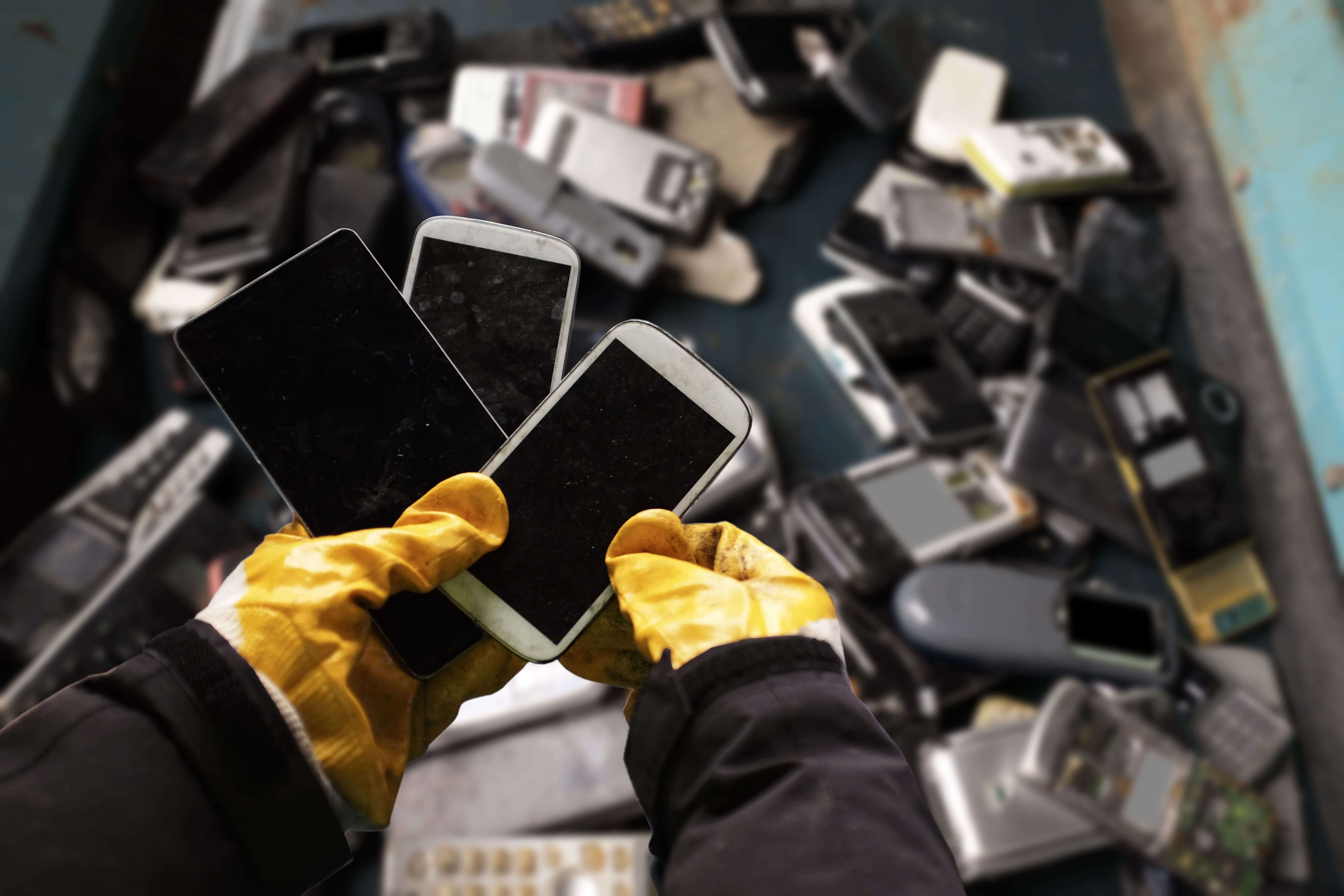 Old mobile phones in a recycling bin
