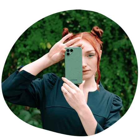 woman holding a Fairphone 4 up to her face