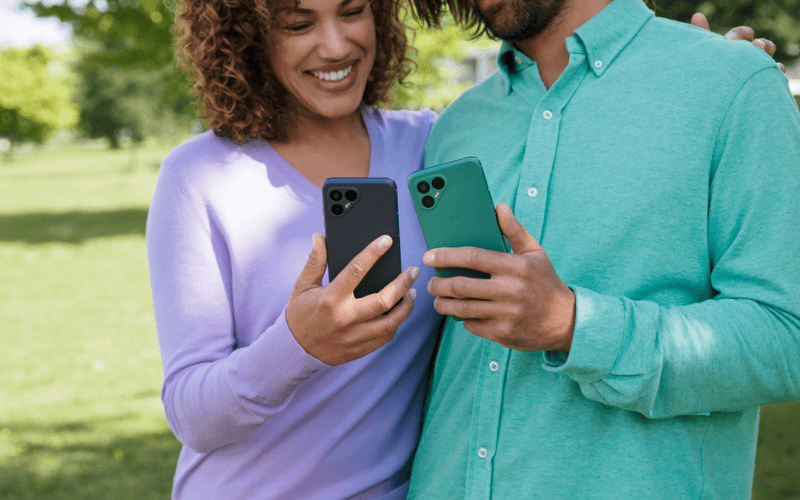 Couple looking at their Fairphone 4 devices